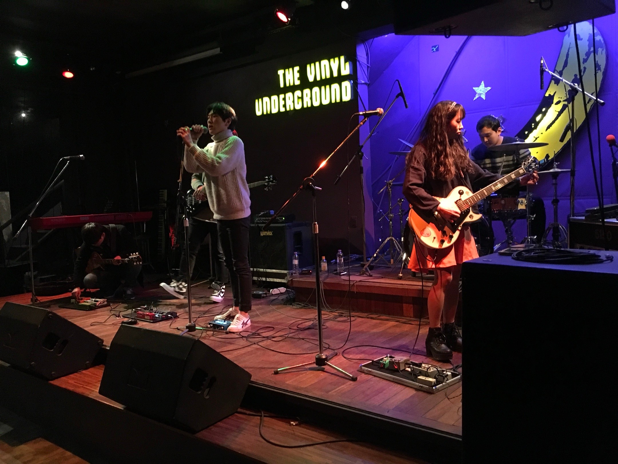 A band performing onstage at The Vinyl Underground